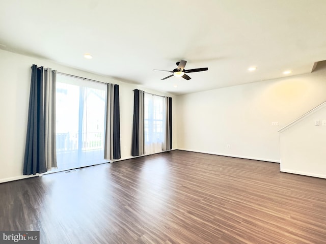 spare room featuring ceiling fan and dark hardwood / wood-style flooring