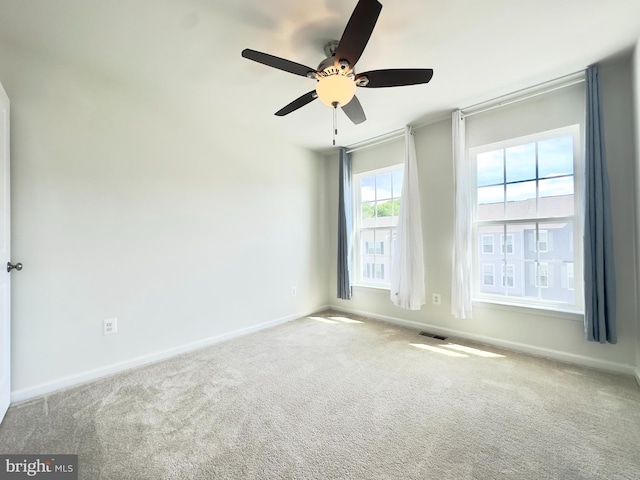 carpeted empty room with ceiling fan