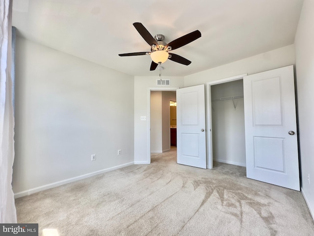 unfurnished bedroom with light carpet, a closet, and ceiling fan