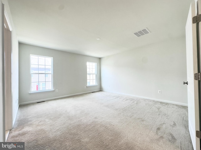 spare room with light colored carpet