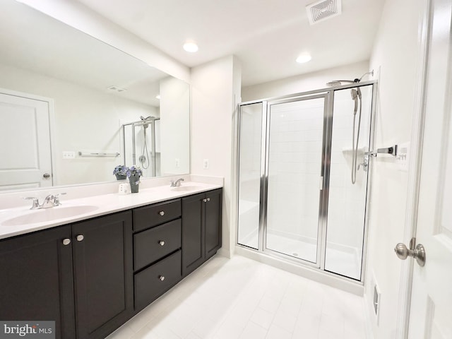 bathroom with an enclosed shower and vanity