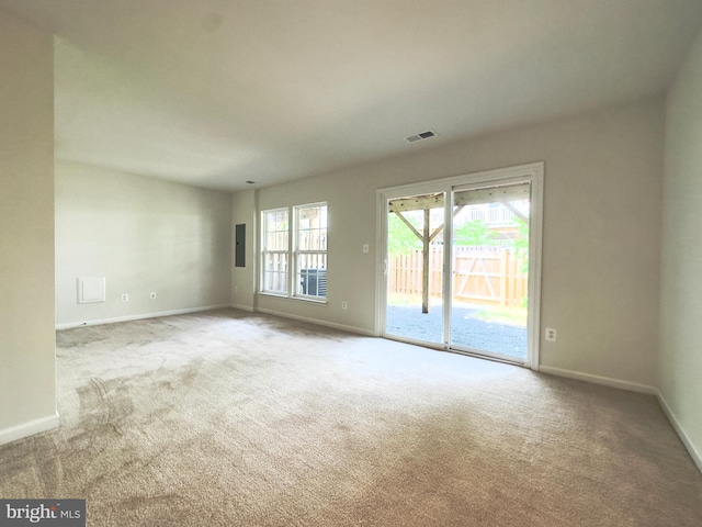 carpeted spare room featuring electric panel