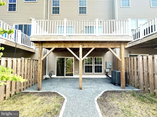 rear view of property with a patio area and central AC unit