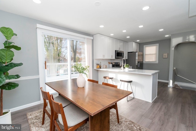 dining space with sink and dark hardwood / wood-style floors