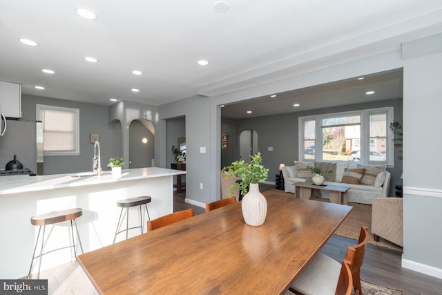 dining room featuring wood-type flooring and sink