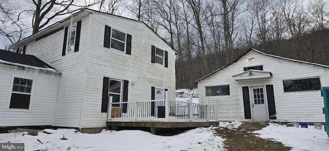 snow covered property featuring a deck