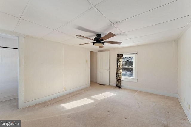 unfurnished bedroom featuring carpet floors, ceiling fan, visible vents, and baseboards