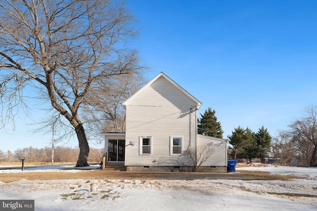 exterior space with a sunroom and crawl space