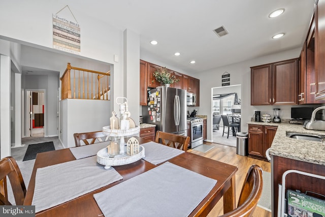 dining room with light hardwood / wood-style flooring and sink