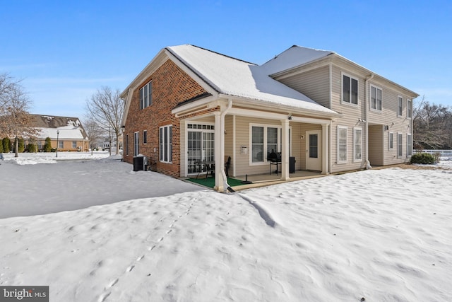 view of snow covered rear of property