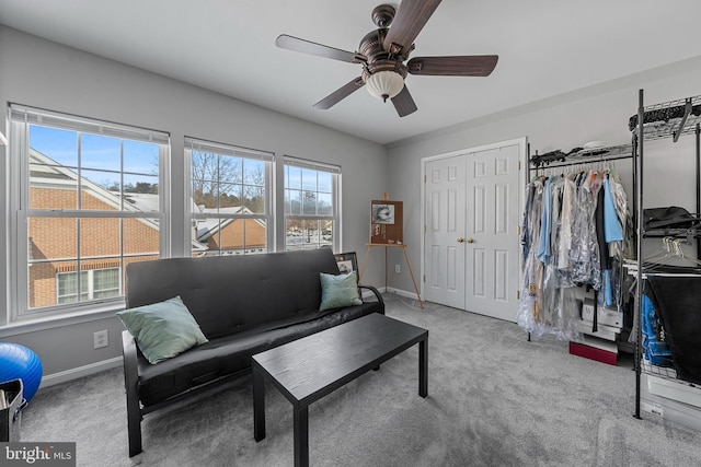 carpeted living room featuring ceiling fan and plenty of natural light