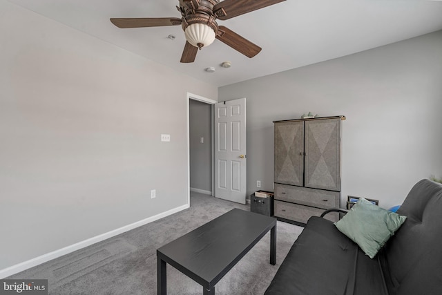 carpeted living room with ceiling fan