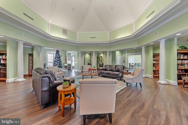 living room with a towering ceiling and ornate columns