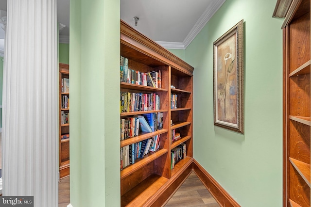 interior space with ornamental molding and wood-type flooring