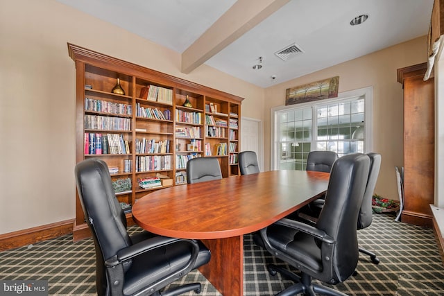 carpeted office featuring beamed ceiling