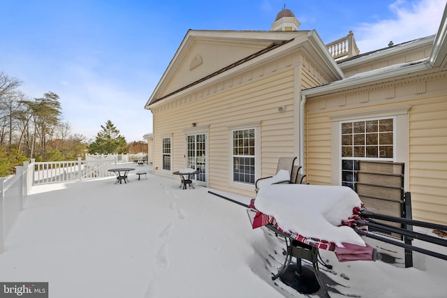 view of snow covered rear of property