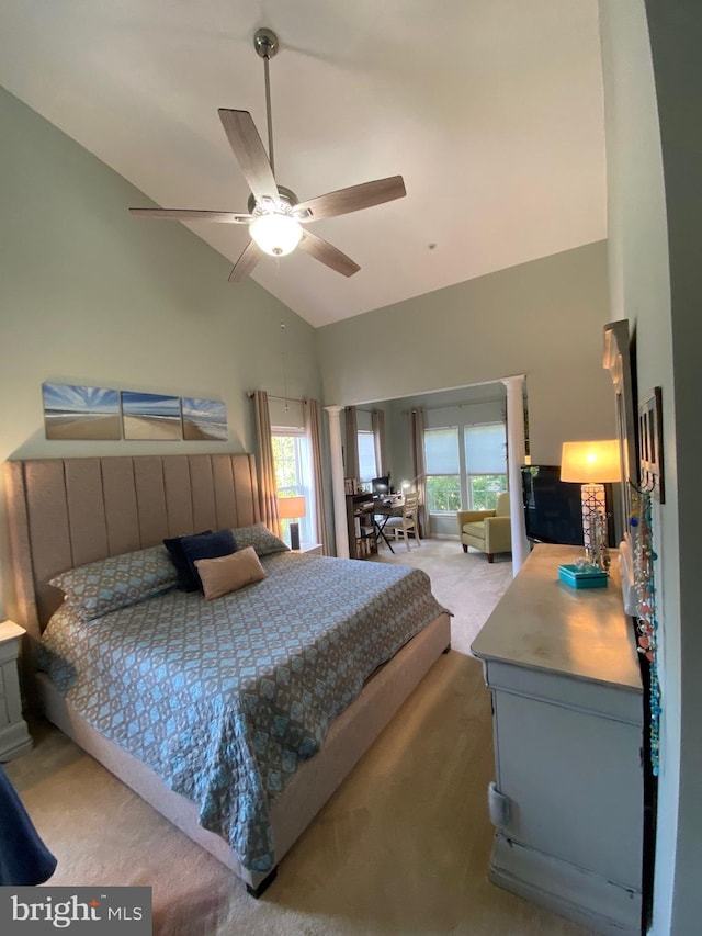 bedroom with ceiling fan, multiple windows, lofted ceiling, and carpet flooring