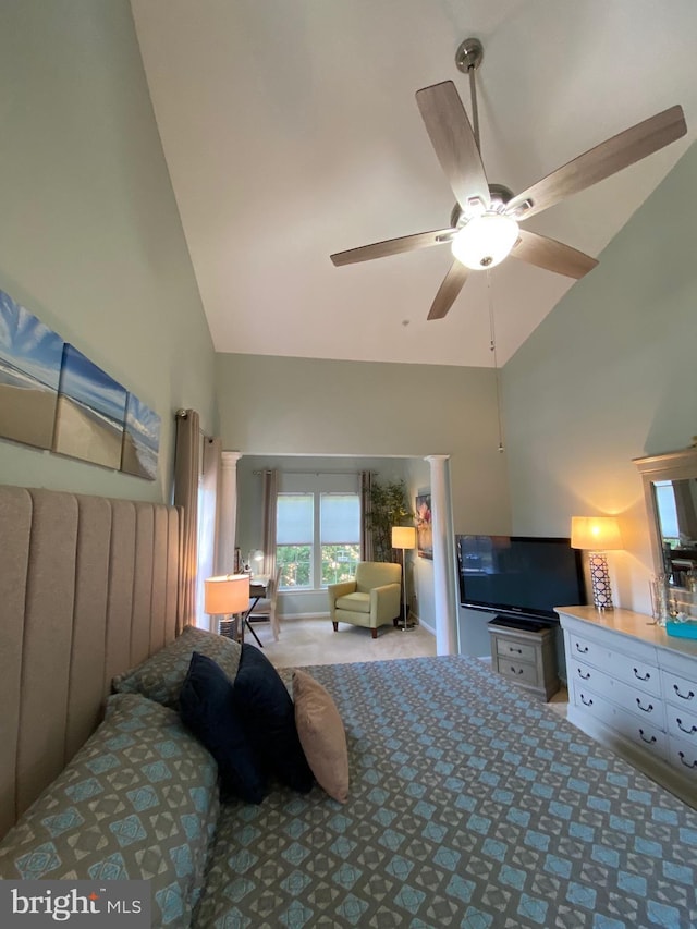 carpeted bedroom featuring ceiling fan and high vaulted ceiling