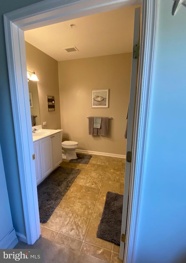 bathroom featuring toilet and vanity