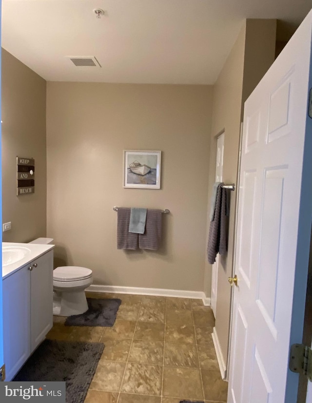 bathroom featuring toilet and vanity