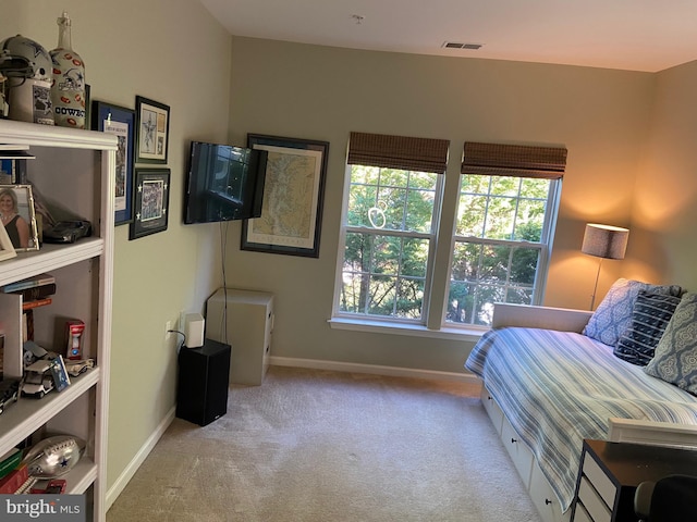 bedroom featuring light colored carpet