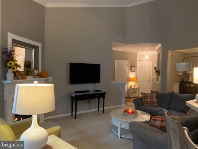 carpeted living room featuring a high ceiling and crown molding