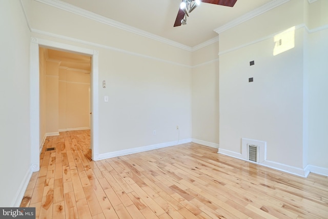 empty room with ornamental molding, ceiling fan, and light wood-type flooring