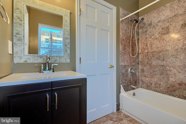 bathroom featuring tiled shower / bath combo and vanity