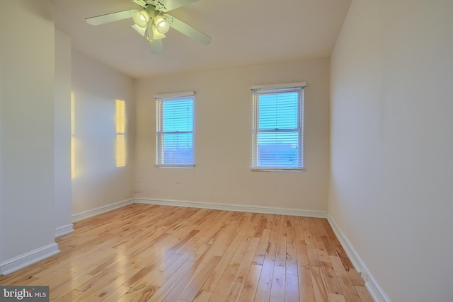 spare room with ceiling fan and light wood-type flooring