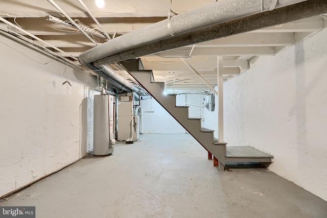 basement featuring water heater, heating unit, and electric panel