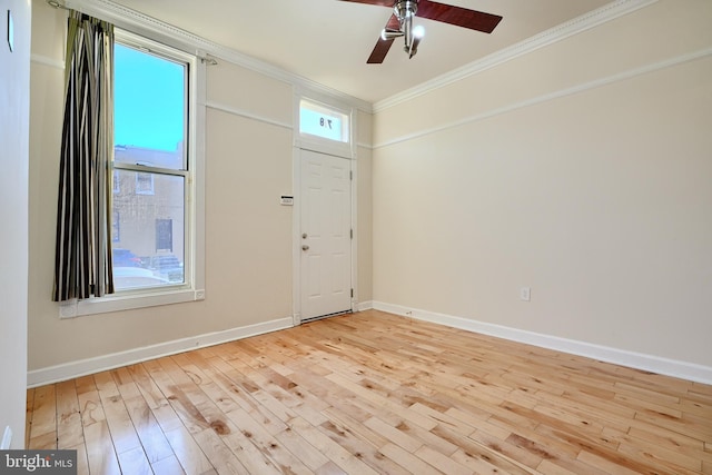 foyer entrance featuring ceiling fan, ornamental molding, and light hardwood / wood-style floors