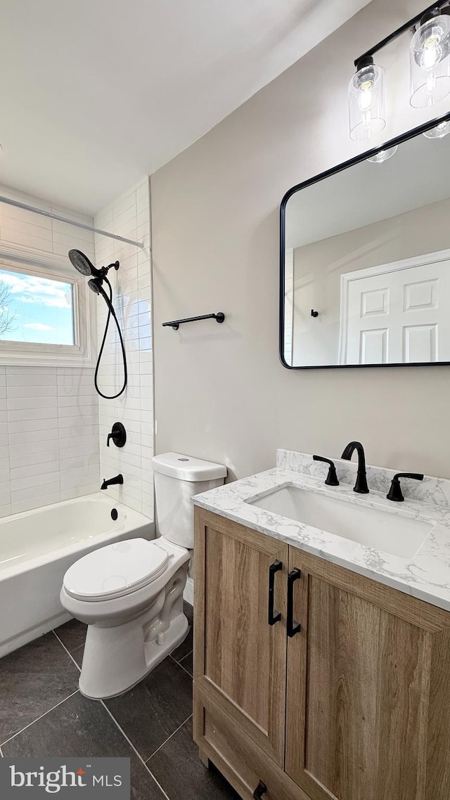 full bathroom featuring vanity, toilet, tile patterned floors, and tiled shower / bath