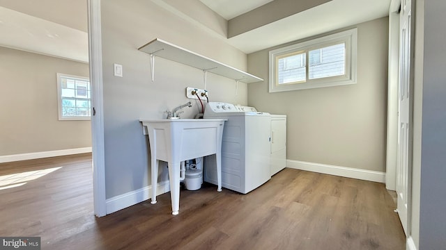 clothes washing area featuring hardwood / wood-style floors and independent washer and dryer