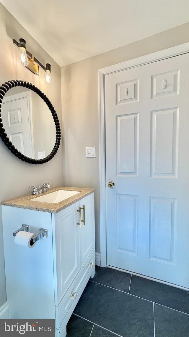 bathroom with tile patterned floors and vanity