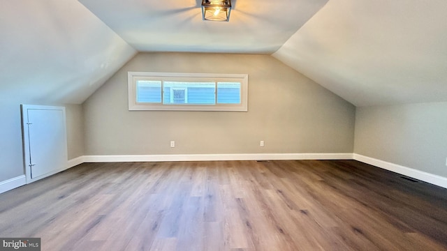 bonus room with light hardwood / wood-style floors and lofted ceiling