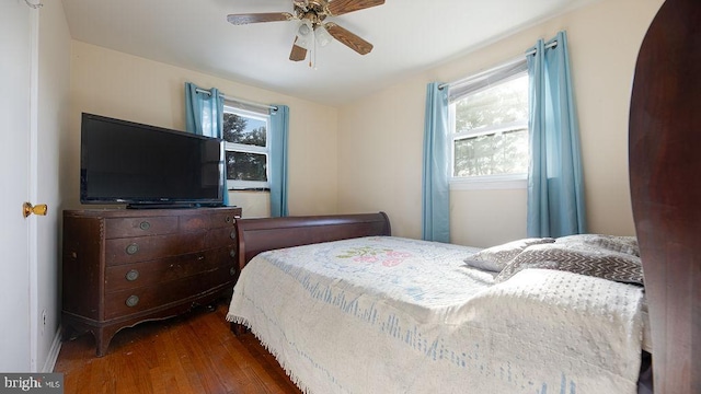 bedroom with ceiling fan and dark wood-type flooring