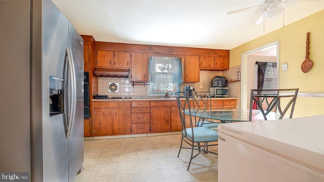 kitchen featuring custom exhaust hood, backsplash, appliances with stainless steel finishes, ceiling fan, and sink