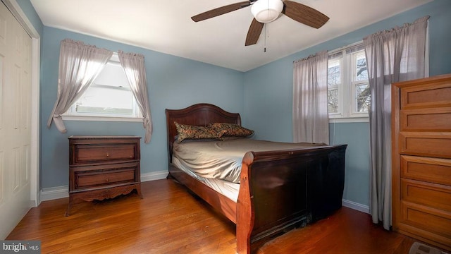 bedroom with ceiling fan, a closet, and multiple windows