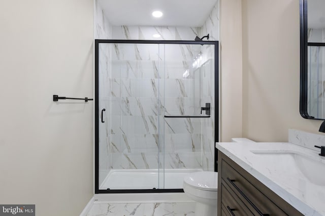 bathroom with toilet, an enclosed shower, and vanity