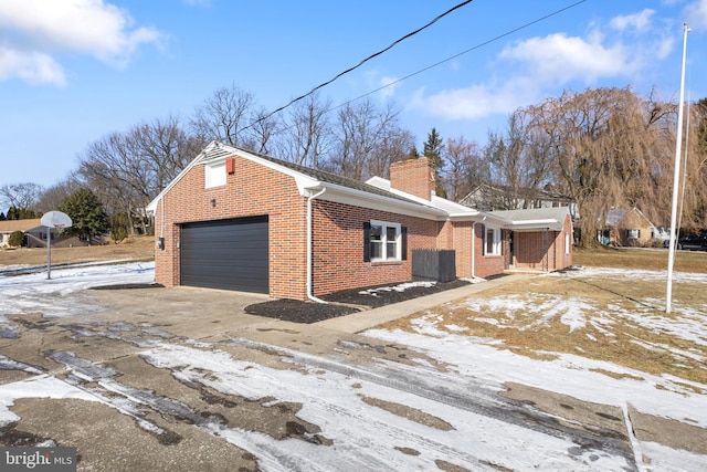 view of snow covered exterior with a garage