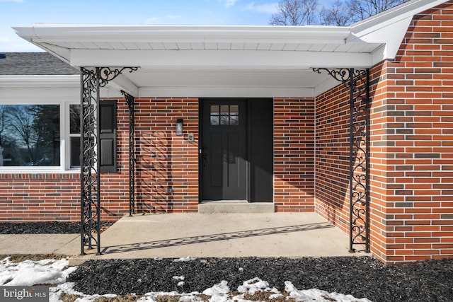 view of snow covered property entrance