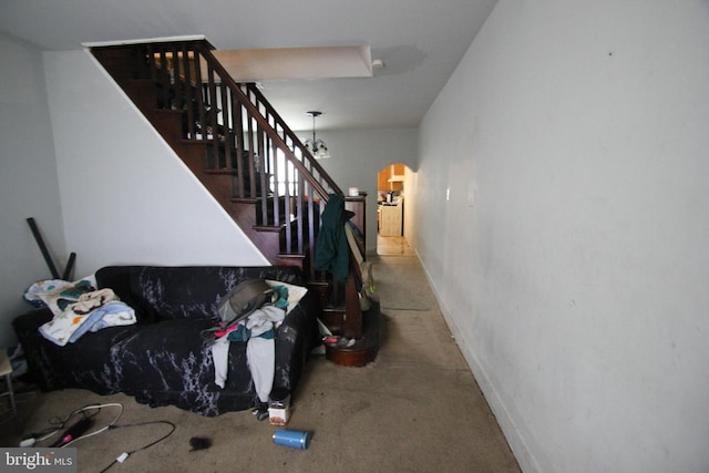 staircase featuring a chandelier and carpet flooring