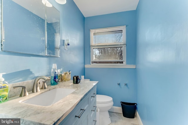 bathroom featuring toilet and vanity