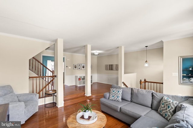 living room with dark hardwood / wood-style flooring and ornamental molding