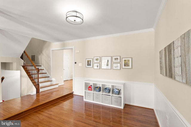 entryway with dark hardwood / wood-style floors and ornamental molding