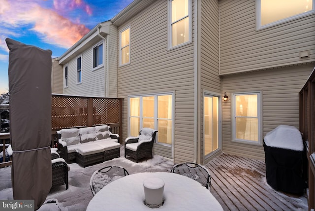 deck at dusk featuring an outdoor hangout area