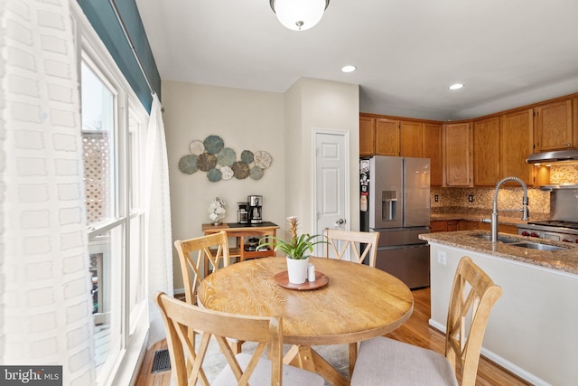 dining space featuring light hardwood / wood-style floors and sink