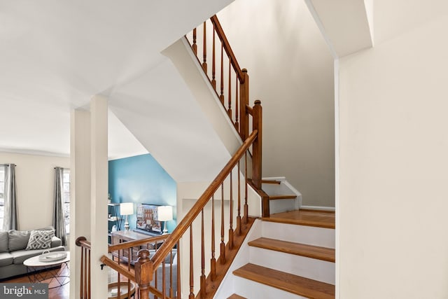 staircase with lofted ceiling