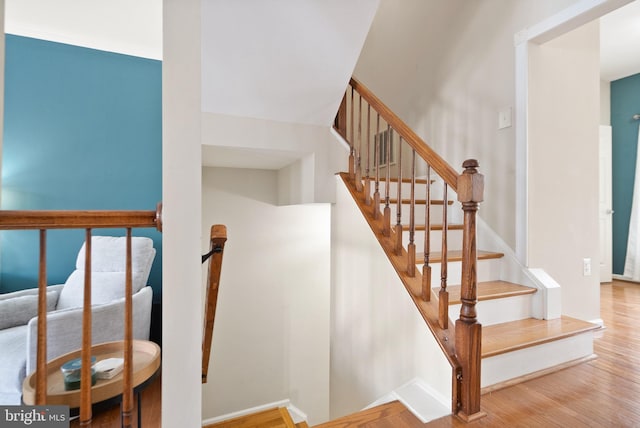 stairway featuring wood-type flooring