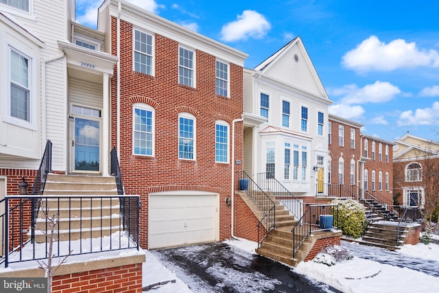 view of property featuring a garage and central AC unit